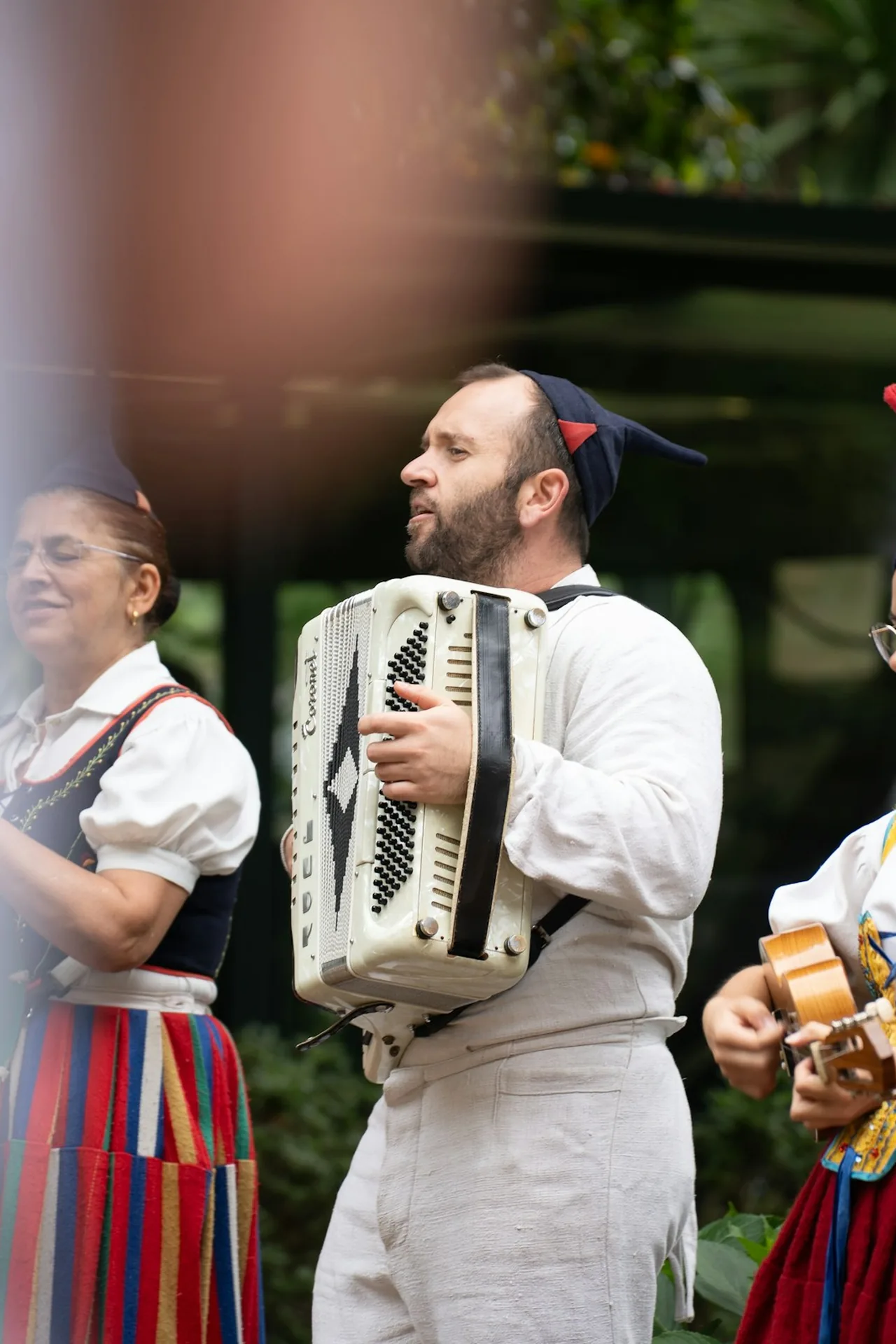 Musicians and dancers in traditional Madeiran costume playing folk instruments outdoors